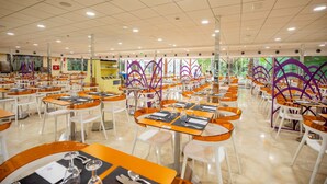 A large dining hall with multiple tables and chairs, arranged in rows. - Hotel Servigroup Venus (Benidorm)