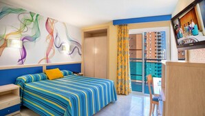 A hotel room with a bed, a desk, a chair, a TV, and a balcony with a view of the city. - Hotel Servigroup Rialto (Benidorm)