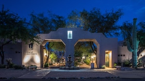A well-lit entrance with a sign reading "Villas of Cave Creek" and a central archway. - Villas of Cave Creek (Cave Creek)