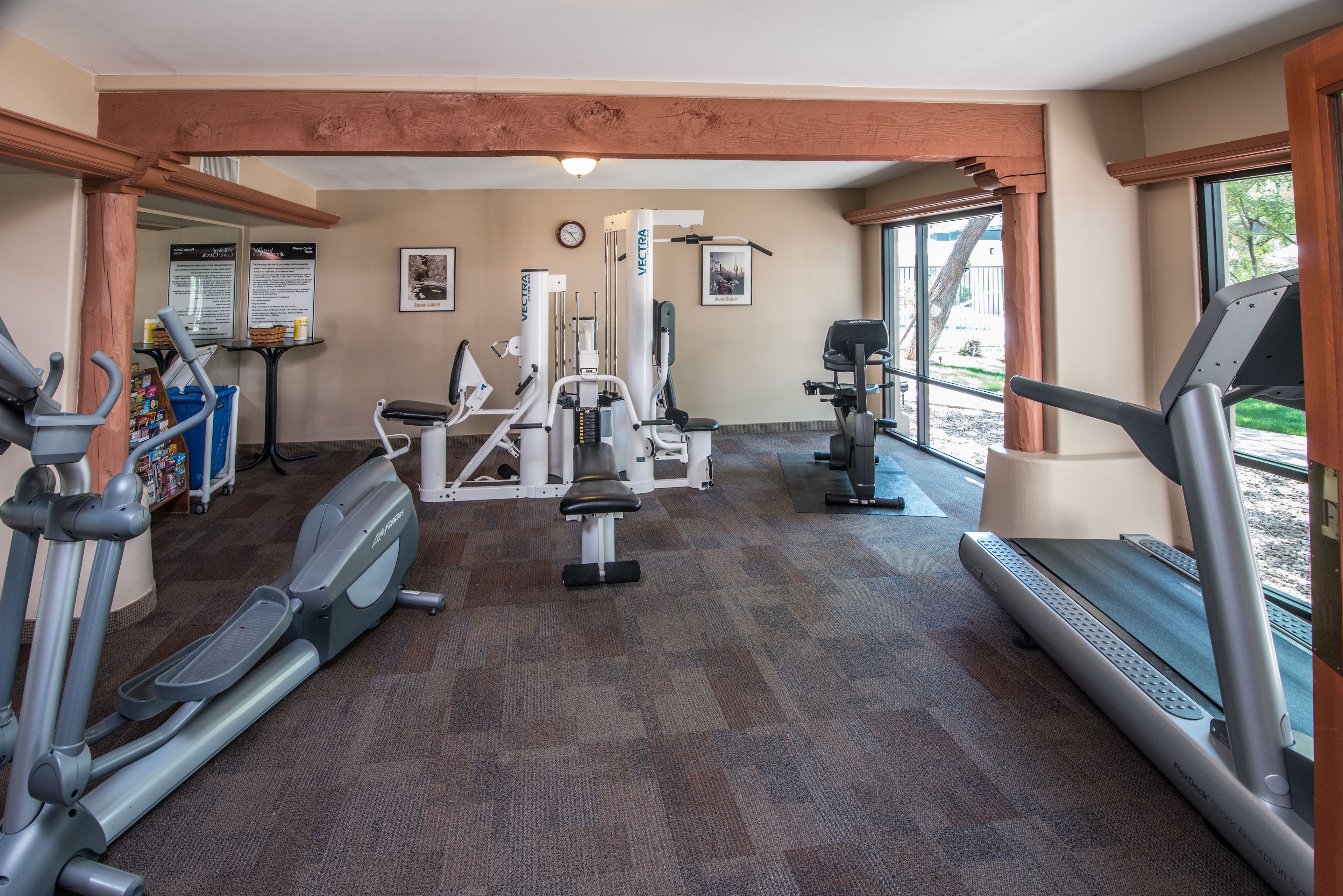 A gym with treadmills, elliptical machines, and weight equipment.