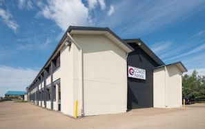 A Coast Hotels building with a flat roof and a sign on the side.