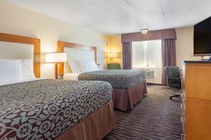 A hotel room with two beds, a desk, a chair, a TV, and a window with curtains. - Days Inn by Wyndham Yakima (Yakima)