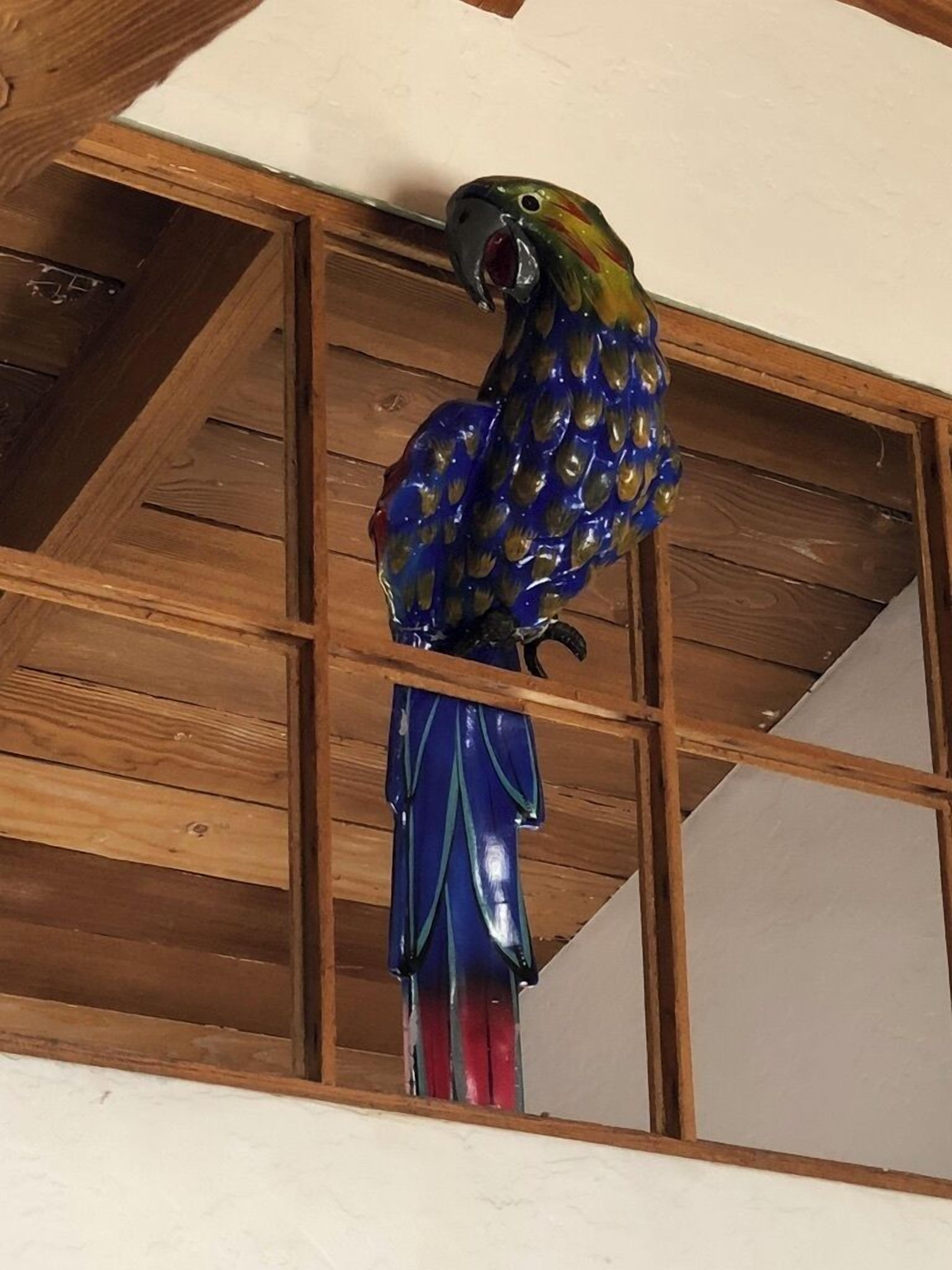 A wooden ceiling with a decorative bird sculpture.