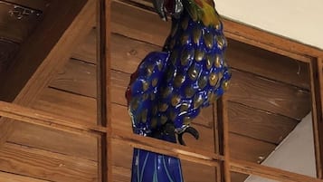 A wooden ceiling with a decorative bird sculpture.
