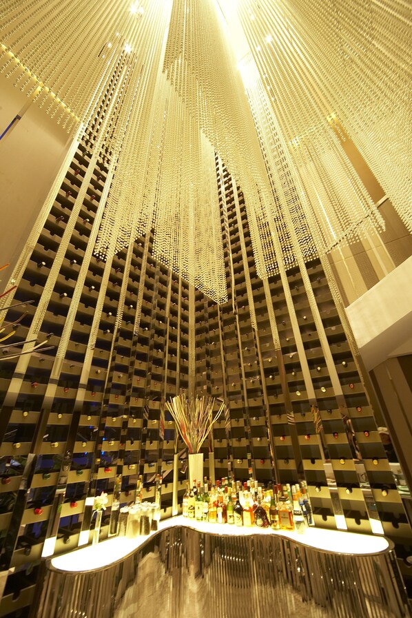 A high-rise building with a reflective glass facade and a bar area at the bottom. - Baiyun Hotel Guangzhou (Guangzhou)