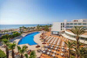 A resort with a large pool, beach area, and a building with multiple floors. - Hotel Servigroup Marina Playa (Mojacar)