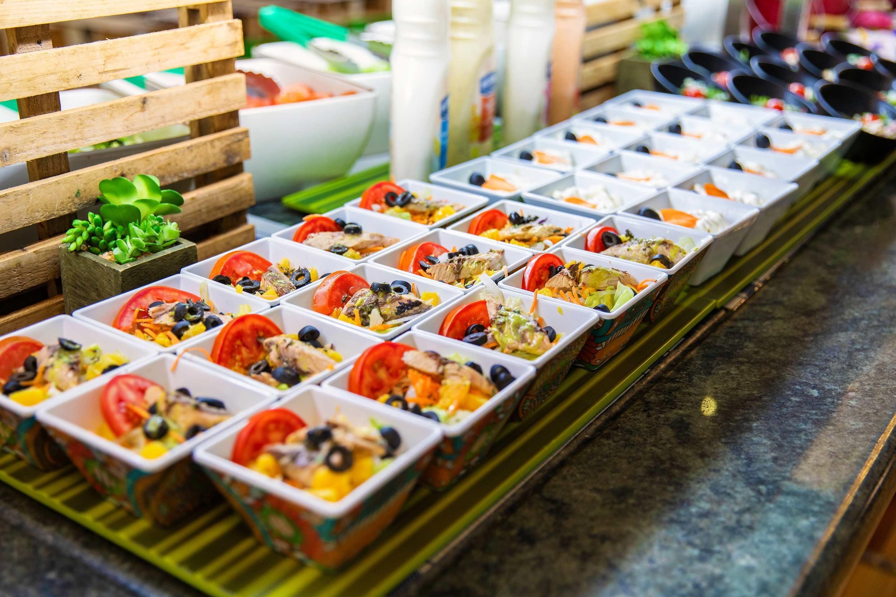 A row of food containers with various ingredients.
