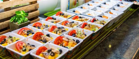 A row of food containers with various ingredients.
