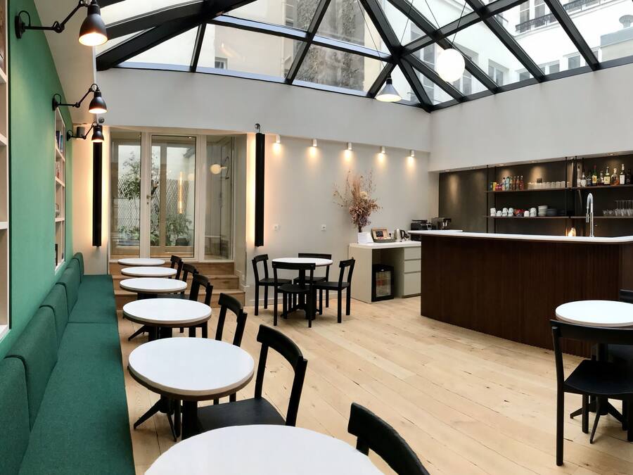 A modern interior with a bar area, seating, and a skylight.