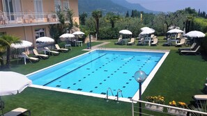 Seasonal outdoor pool, pool umbrellas, pool loungers