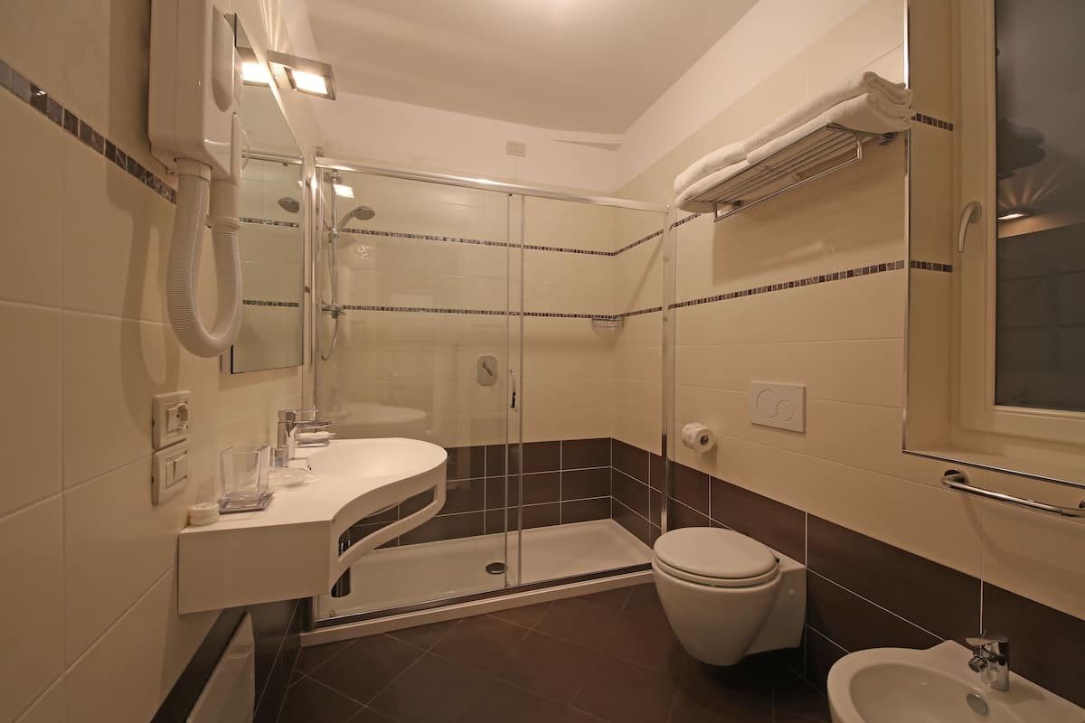 superior triple room | bathroom | rainfall showerhead, free toiletries, hair dryer, bidet