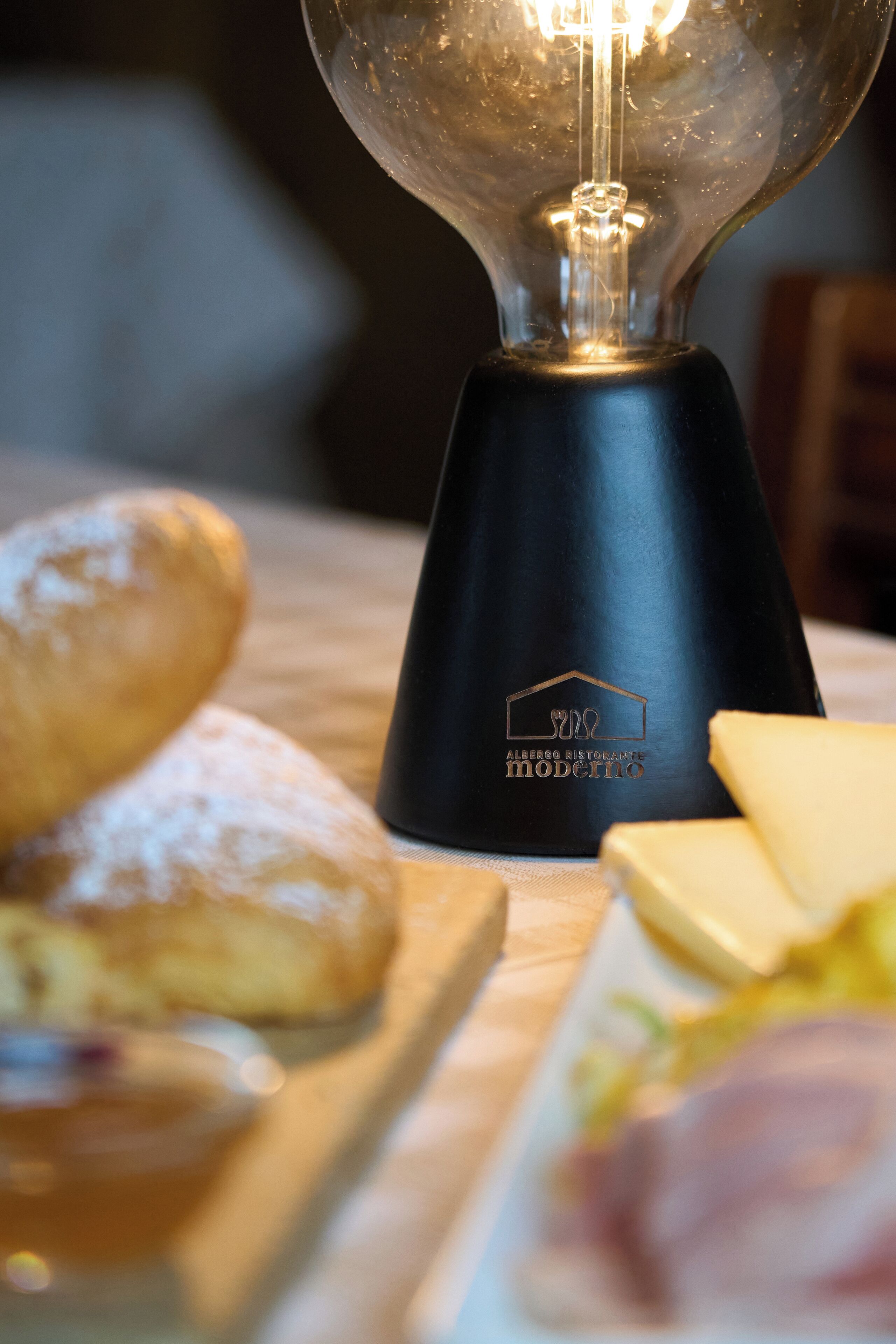 A table with a light bulb, bread, and cheese.