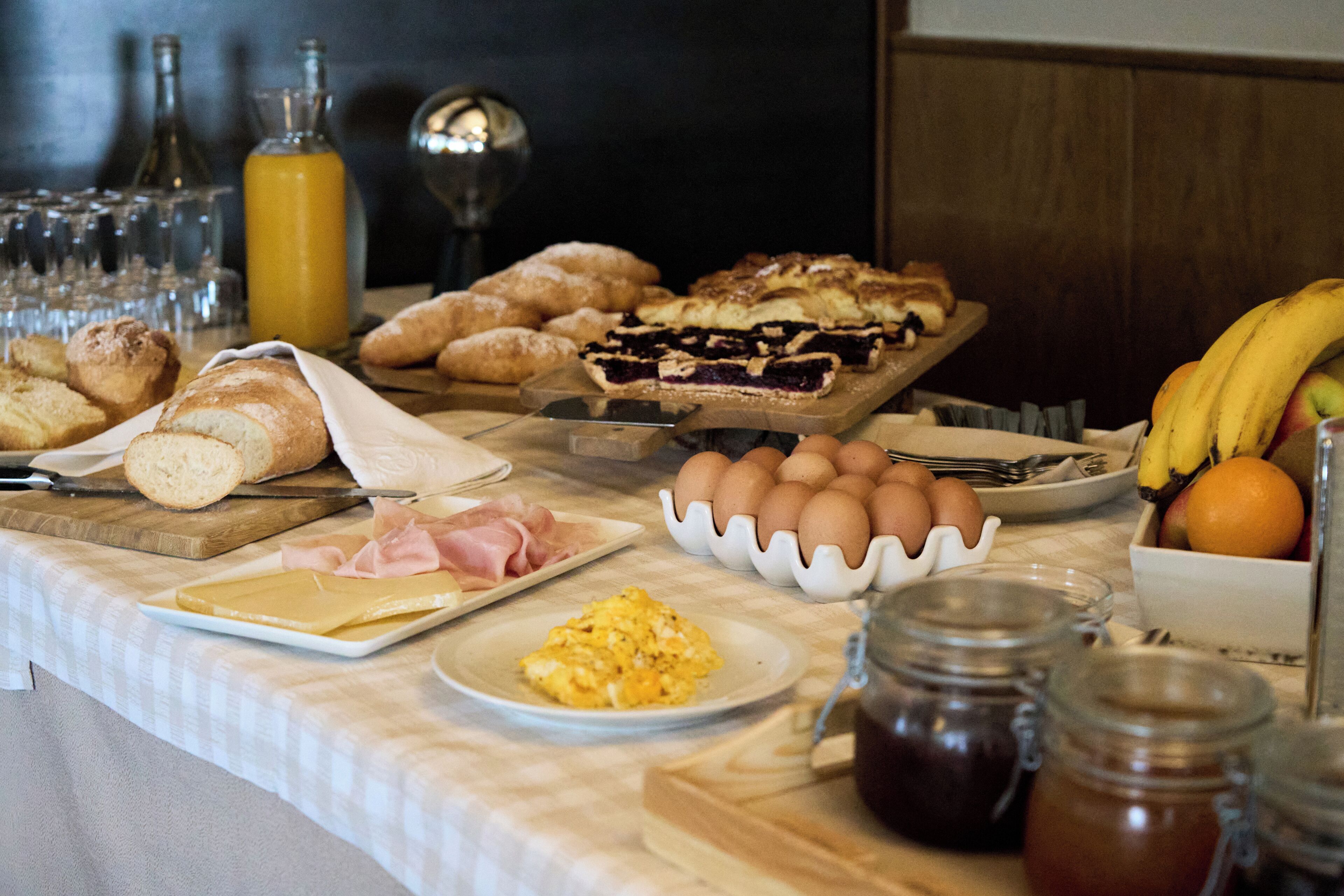 A breakfast buffet with various food items and condiments.