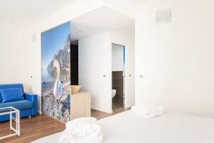 Deluxe Quadruple Room | Down comforters, in-room safe, individually decorated, desk