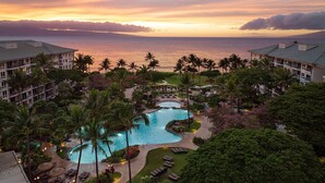A resort with a large pool, palm trees, and a view of the ocean at sunset. - The Westin Ka'anapali Ocean Resort Villas (Lahaina)