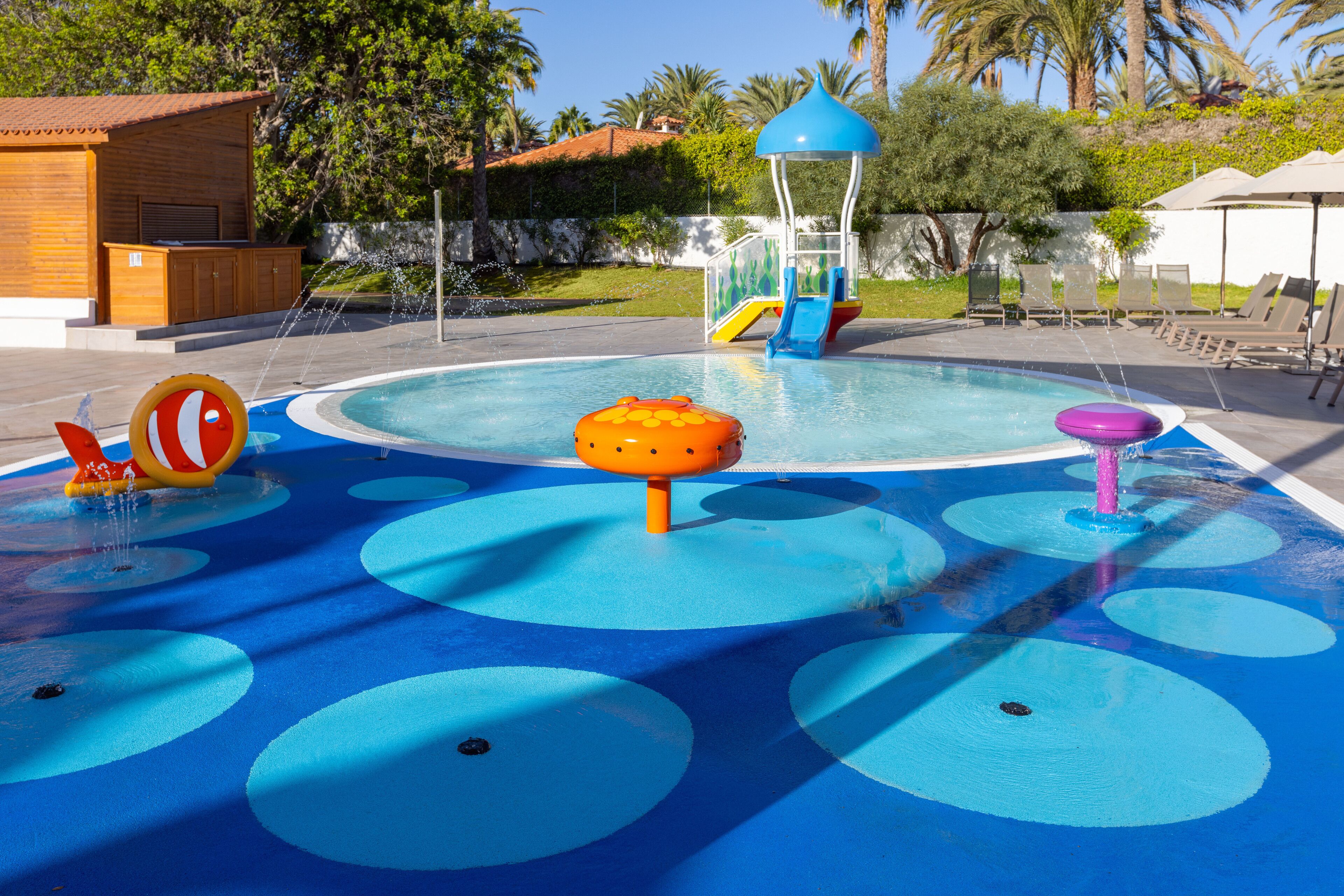 A water play area with a pool, slides, and various water features.