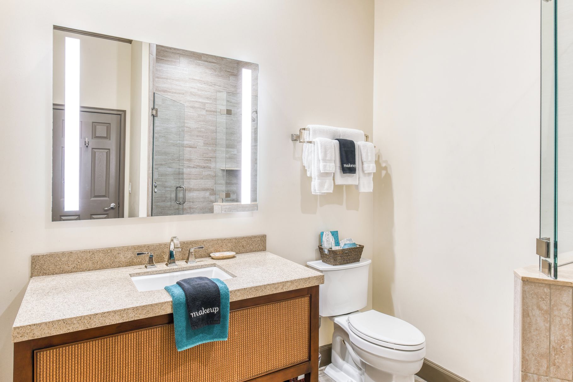 A bathroom with a sink, mirror, towel rack, and toilet.
