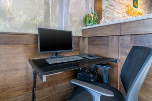 A modern office desk with a computer, keyboard, and chair.