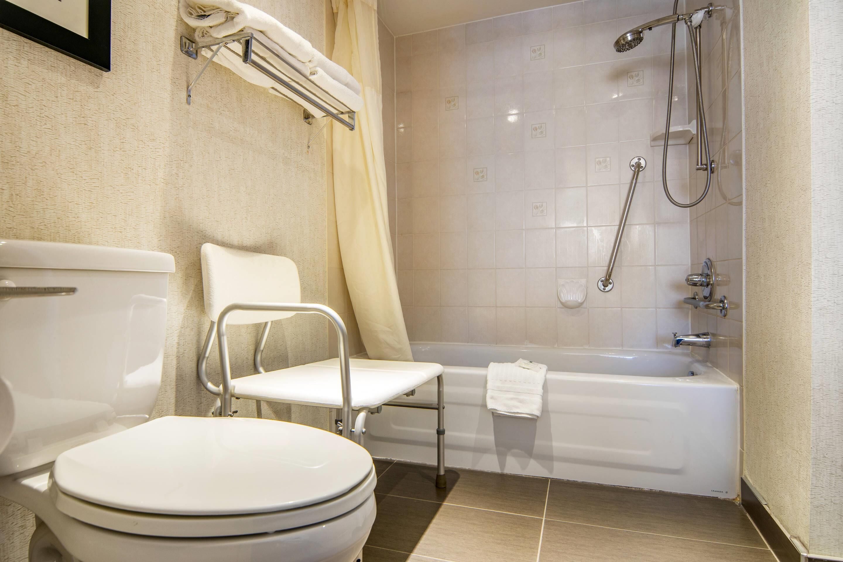 A bathroom with a toilet, a shower, and a bathtub.