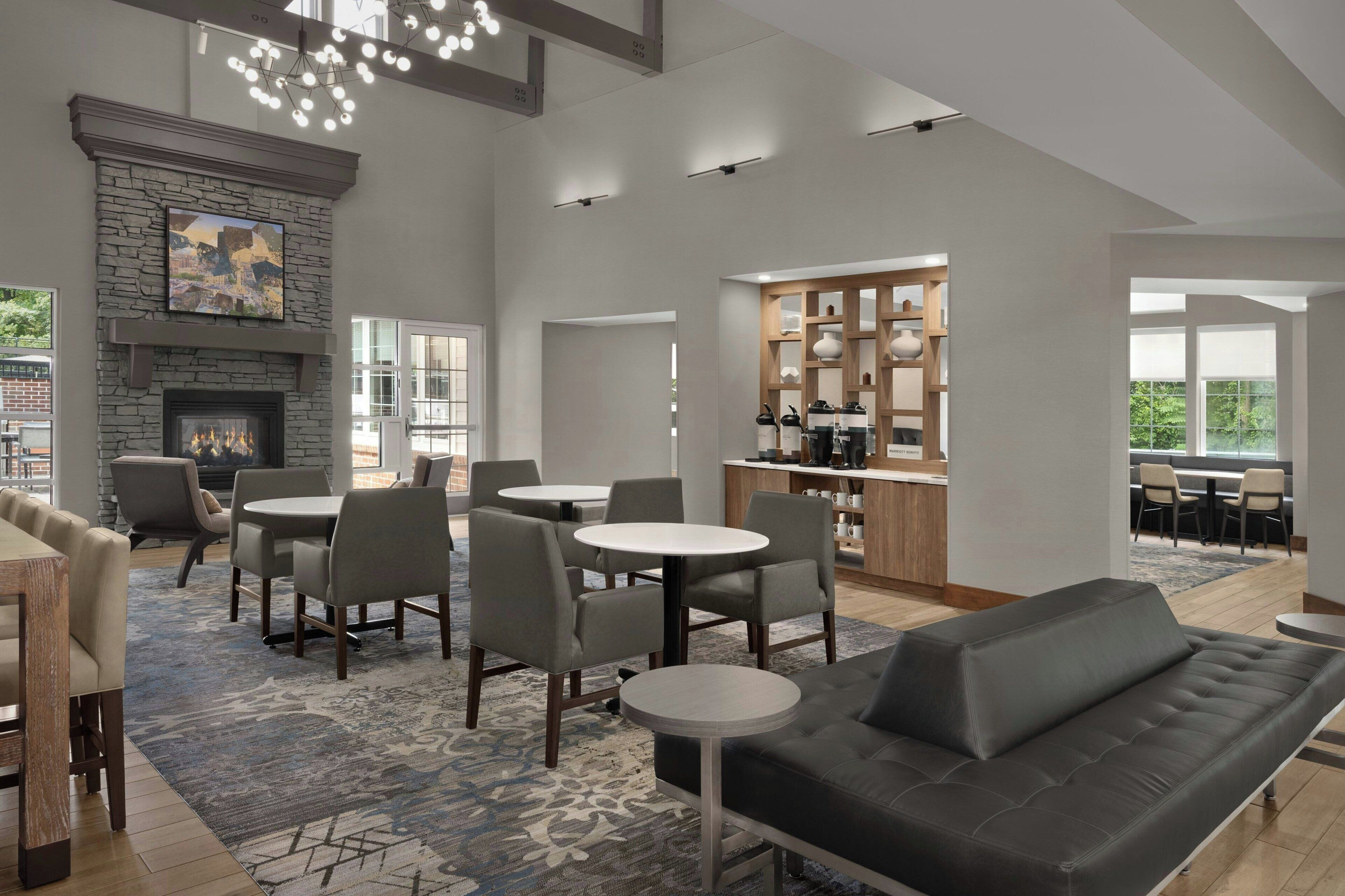 A modern interior with a fireplace, dining area, and kitchen.