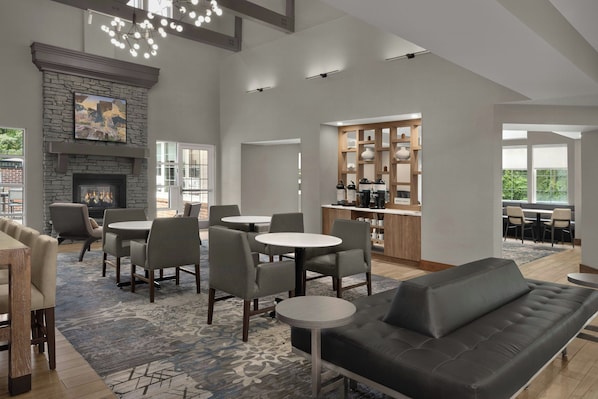 A modern interior with a fireplace, dining area, and kitchen. - Residence Inn by Marriott Arundel Mills BWI Airport (Hanover)