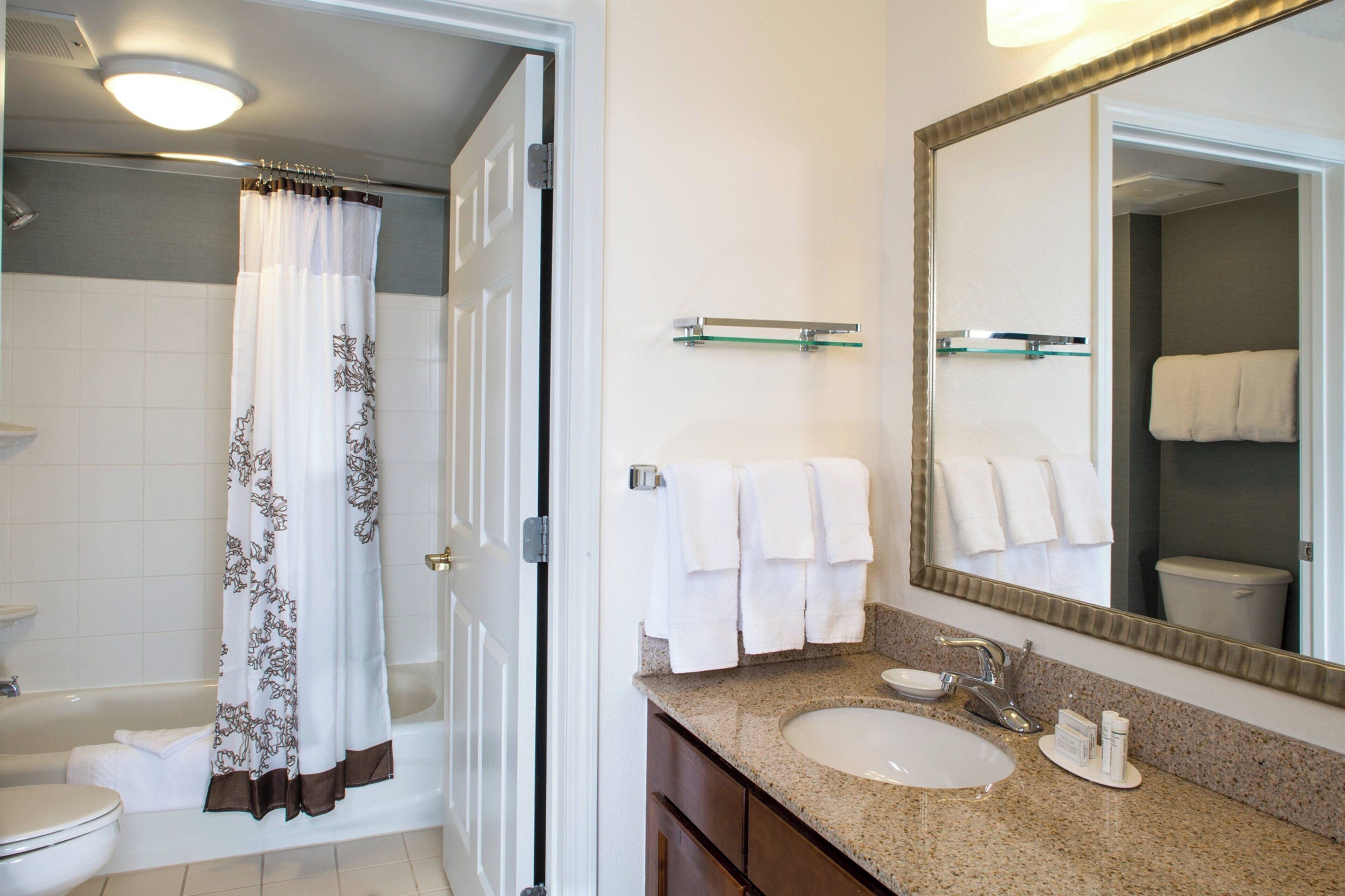 combined shower/bathtub, designer toiletries, hair dryer, towels