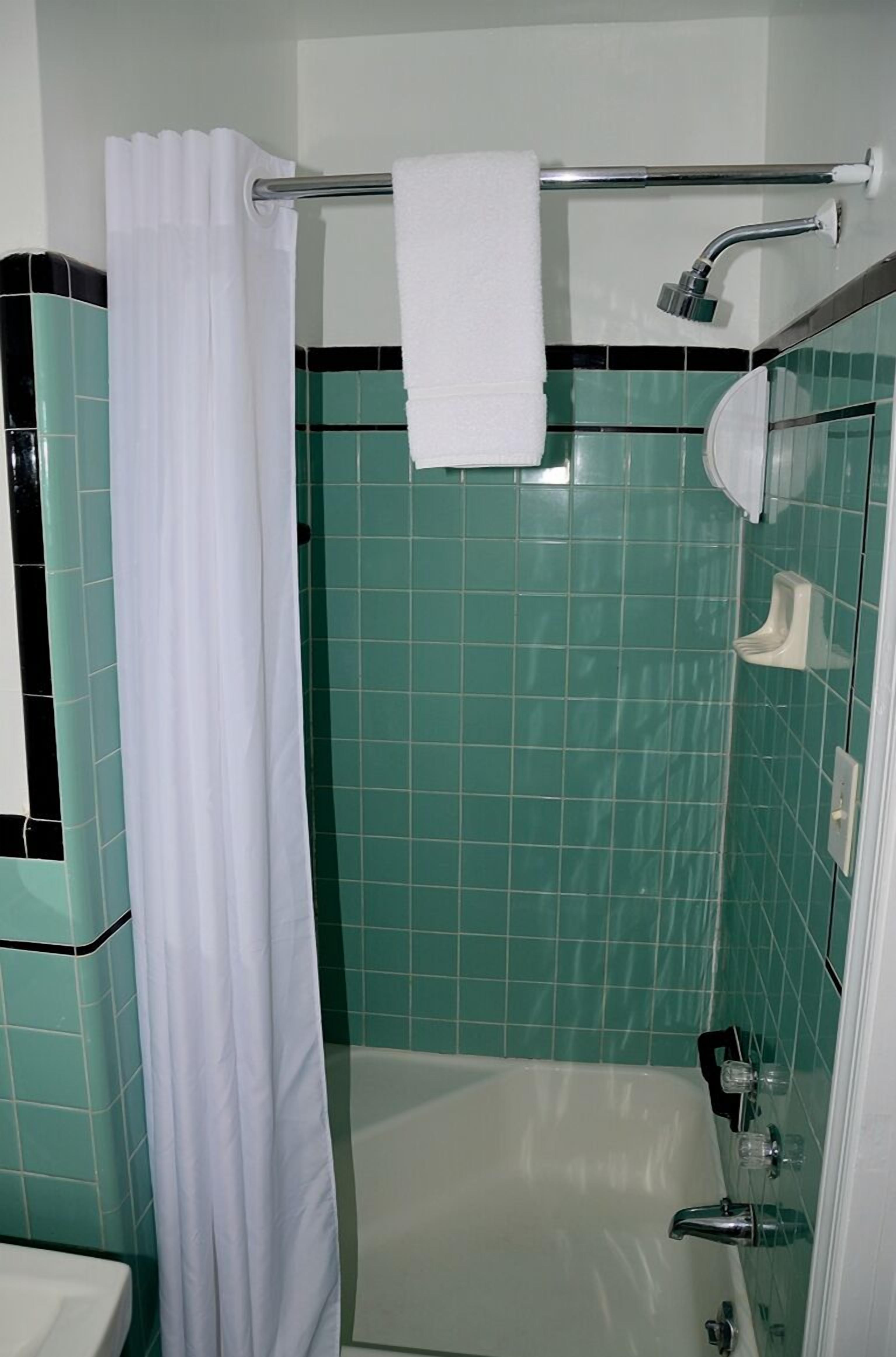 Une salle de bain avec une douche, une baignoire et des toilettes.