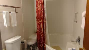 A bathroom with a toilet, sink, and bathtub.