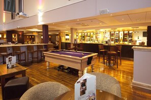 A billiards table in a hotel lobby with a bar and seating area. - Premier Inn London Heathrow Airport T2 & T3 - Bath Road (Hounslow)