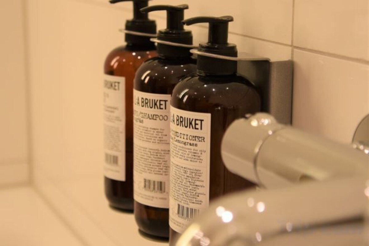 Three bottles of shampoo and conditioner on a bathroom counter.