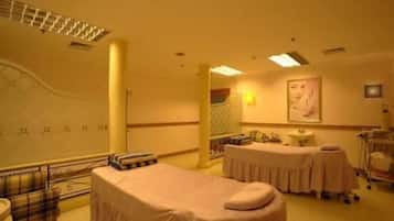 Relax in this serene space with two massage tables and a large window offering a view of the outside.