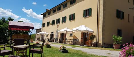 A building with outdoor seating and a garden.