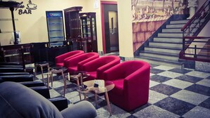 A bar area with red seating, a Pepsi refrigerator, and a mural on the wall. - Bucharest Comfort Suites (Bucharest)