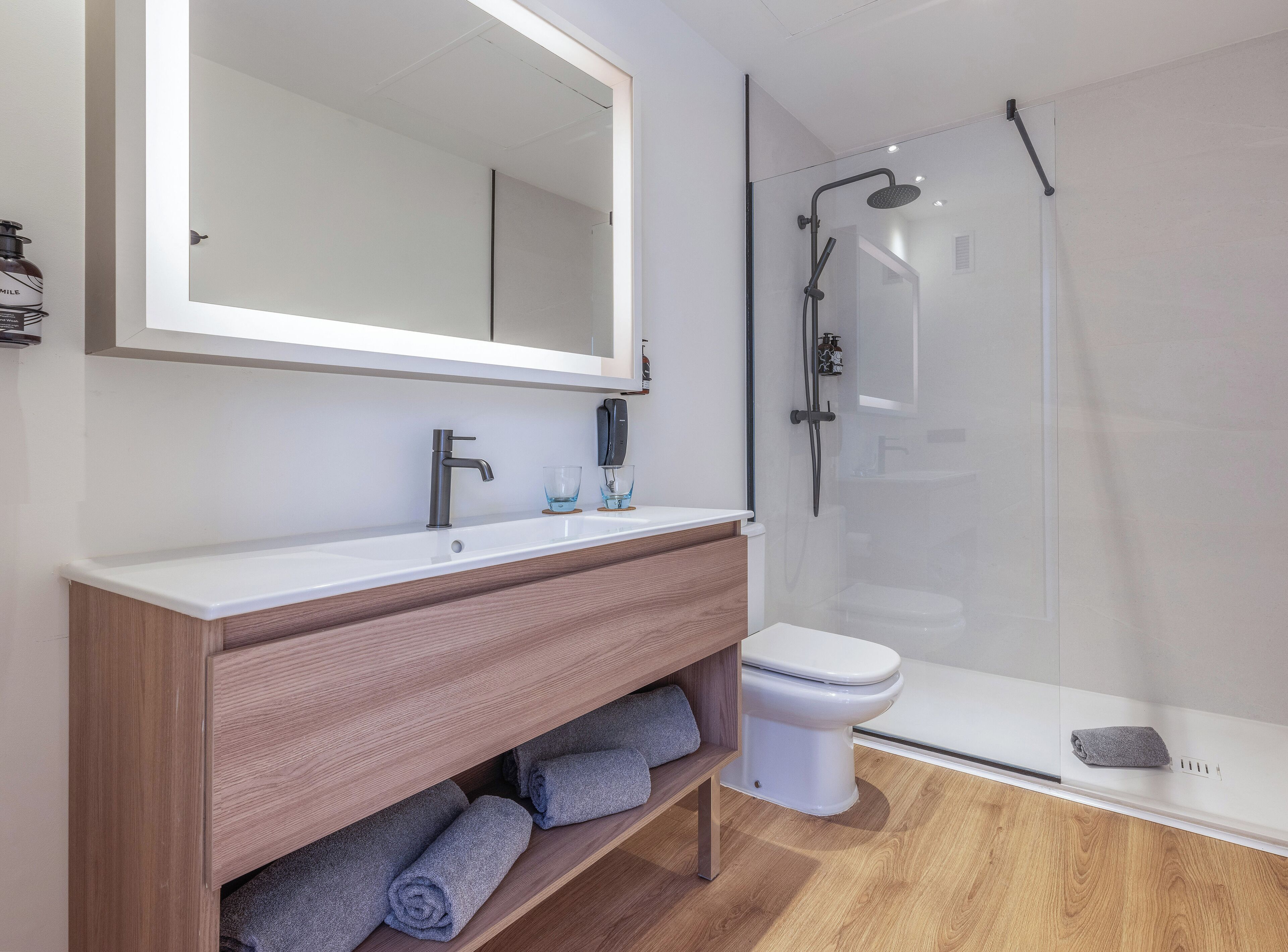 designer toiletries, hair dryer, towels, soap