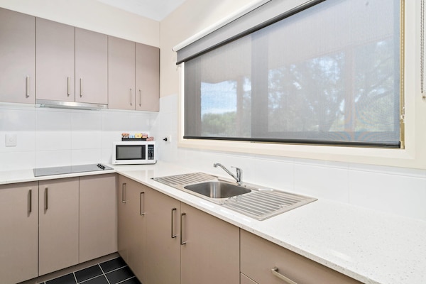Desk, laptop workspace, blackout drapes, iron/ironing board
