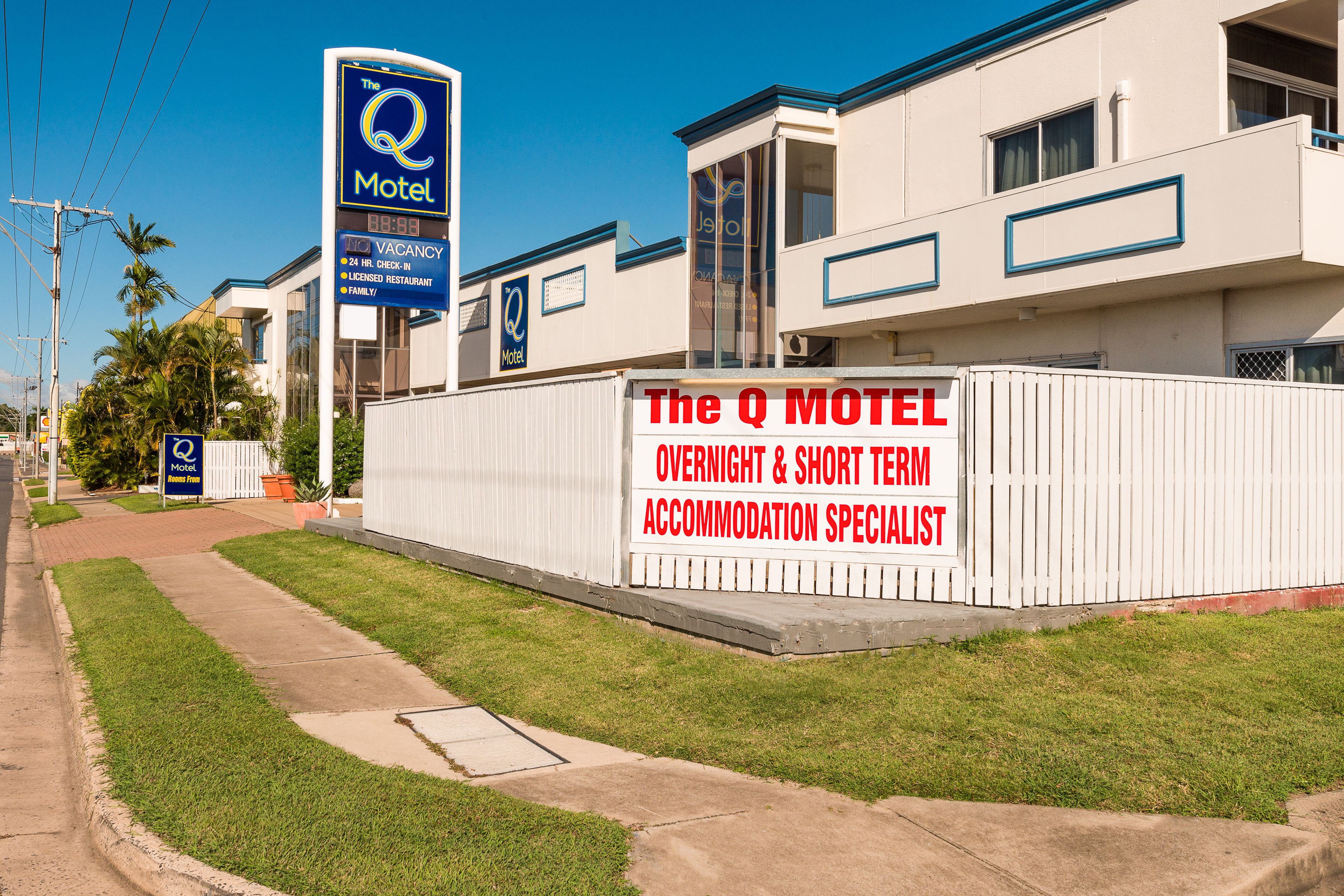 Un motel con un letrero que indica servicios especializados en alojamiento nocturno y estancias cortas.