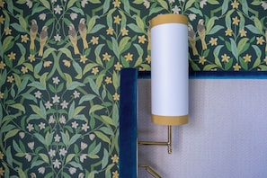 A wall with a floral pattern and a light fixture with a gold-colored base. - Palazzo Excelsior - The Leading Hotels of the World (Palermo)