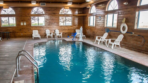 An indoor swimming pool with wooden walls and arched windows. - Quality Inn & Suites Loves Park near Rockford (Loves Park)