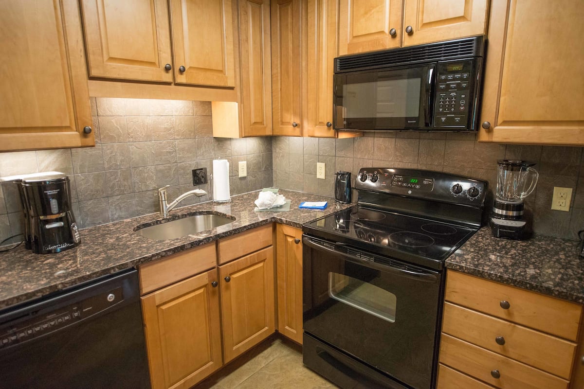 full-sized fridge, microwave, stovetop, dishwasher