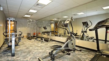 A gym with treadmills, ellipticals, and a stair climber.