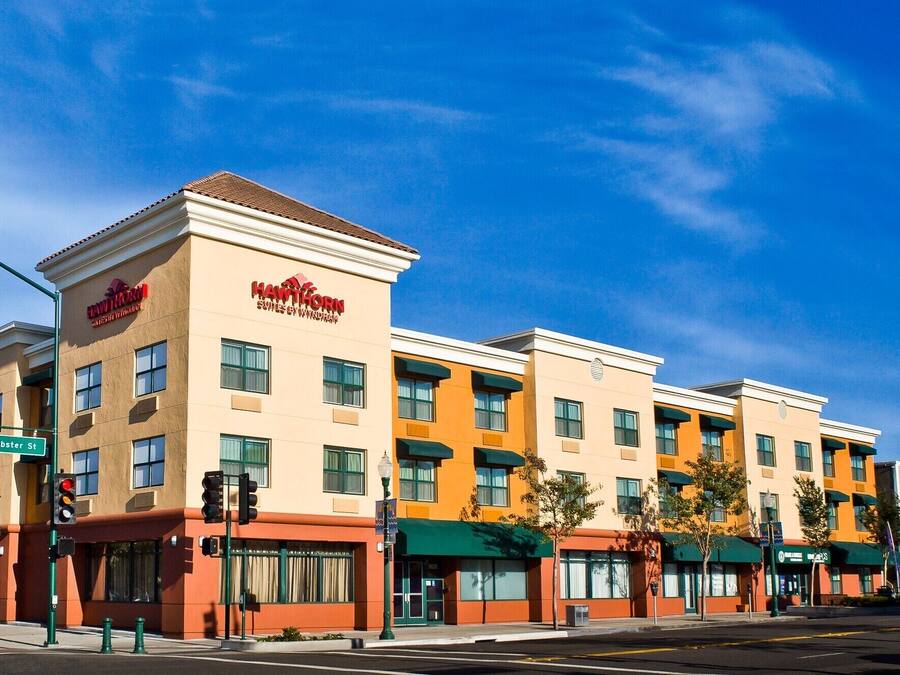 A multi-story hotel with a flat facade, multiple balconies, and a prominent sign.