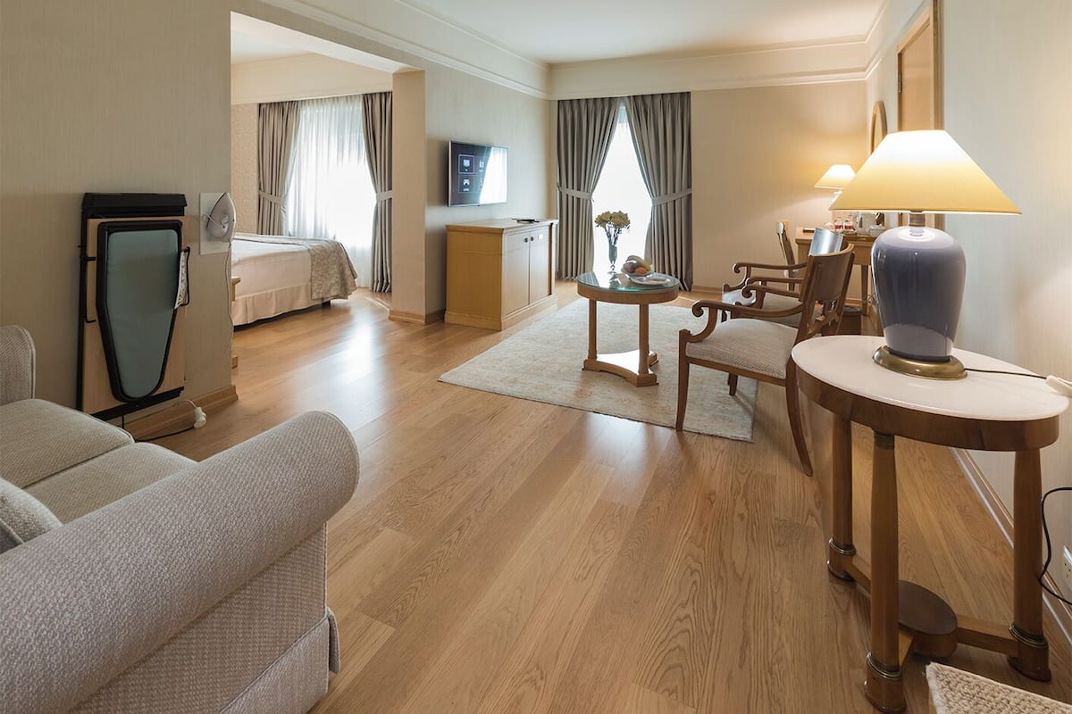 junior suite, 1 queen bed, city view | living area | 42-inch led tv with satellite channels, tv