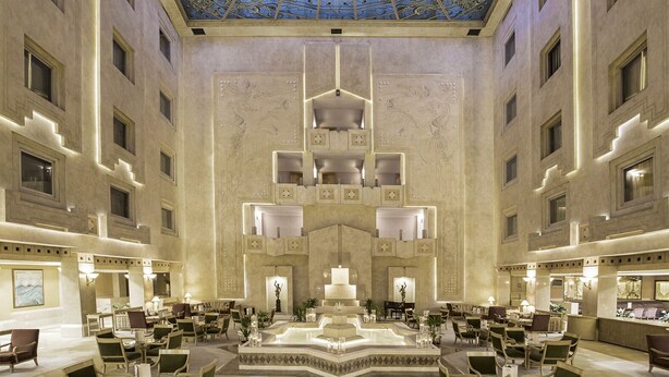 A spacious lobby with a high ceiling and a central fountain, featuring a modern chandelier and seating areas. - Zorlu Grand Hotel Trabzon (Trabzon)