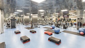 A gym with various exercise equipment, including treadmills, weight machines, and exercise balls. - Zorlu Grand Hotel Trabzon (Trabzon)