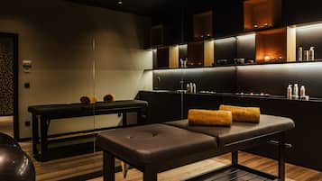 Experience a serene spa retreat with a massage table, bench, and spa products at your fingertips.