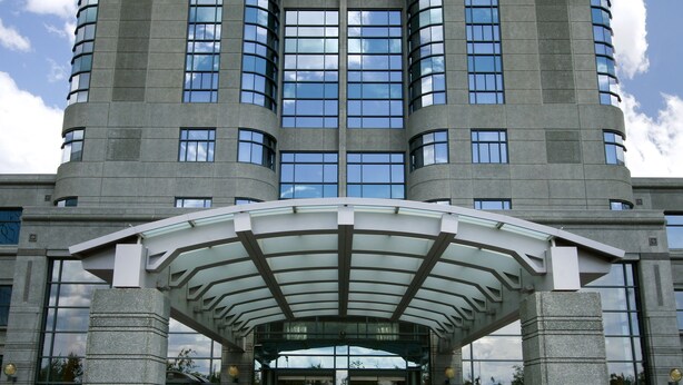 A modern building with a curved entrance and a glass facade. - Brookstreet (Ottawa)