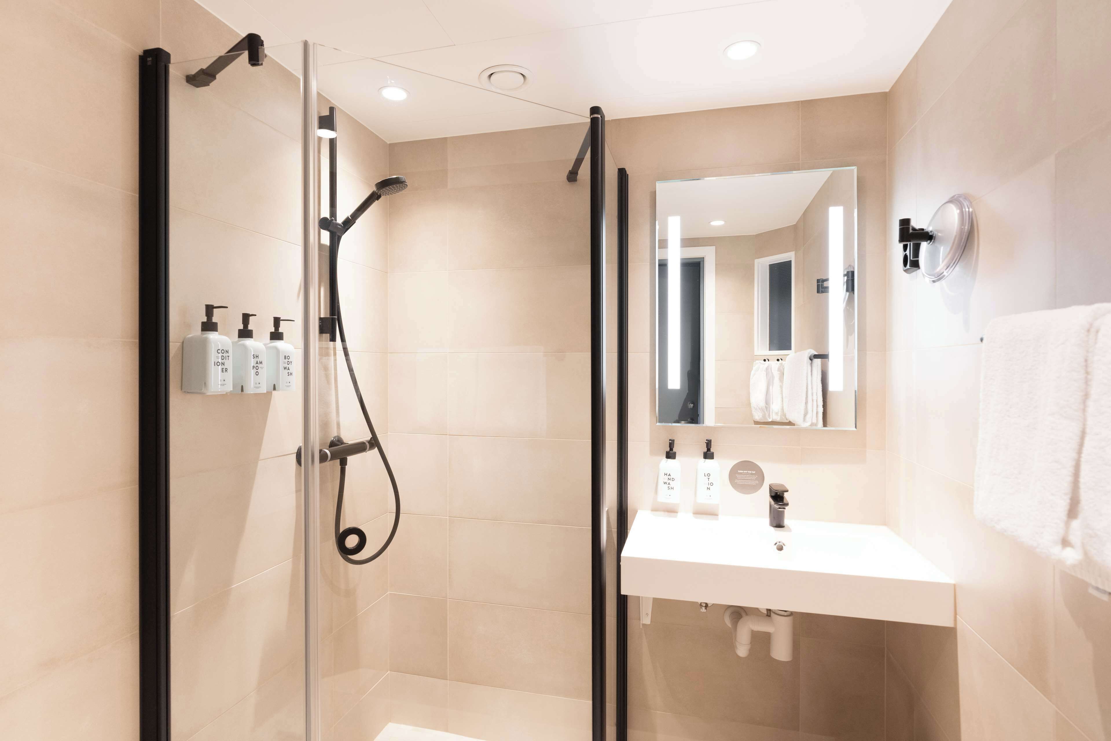 superior twin room | bathroom | hair dryer, towels, soap, shampoo