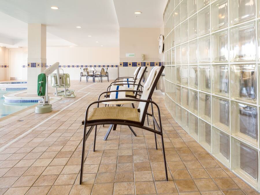 Una piscina techada, sillones reclinables de piscina