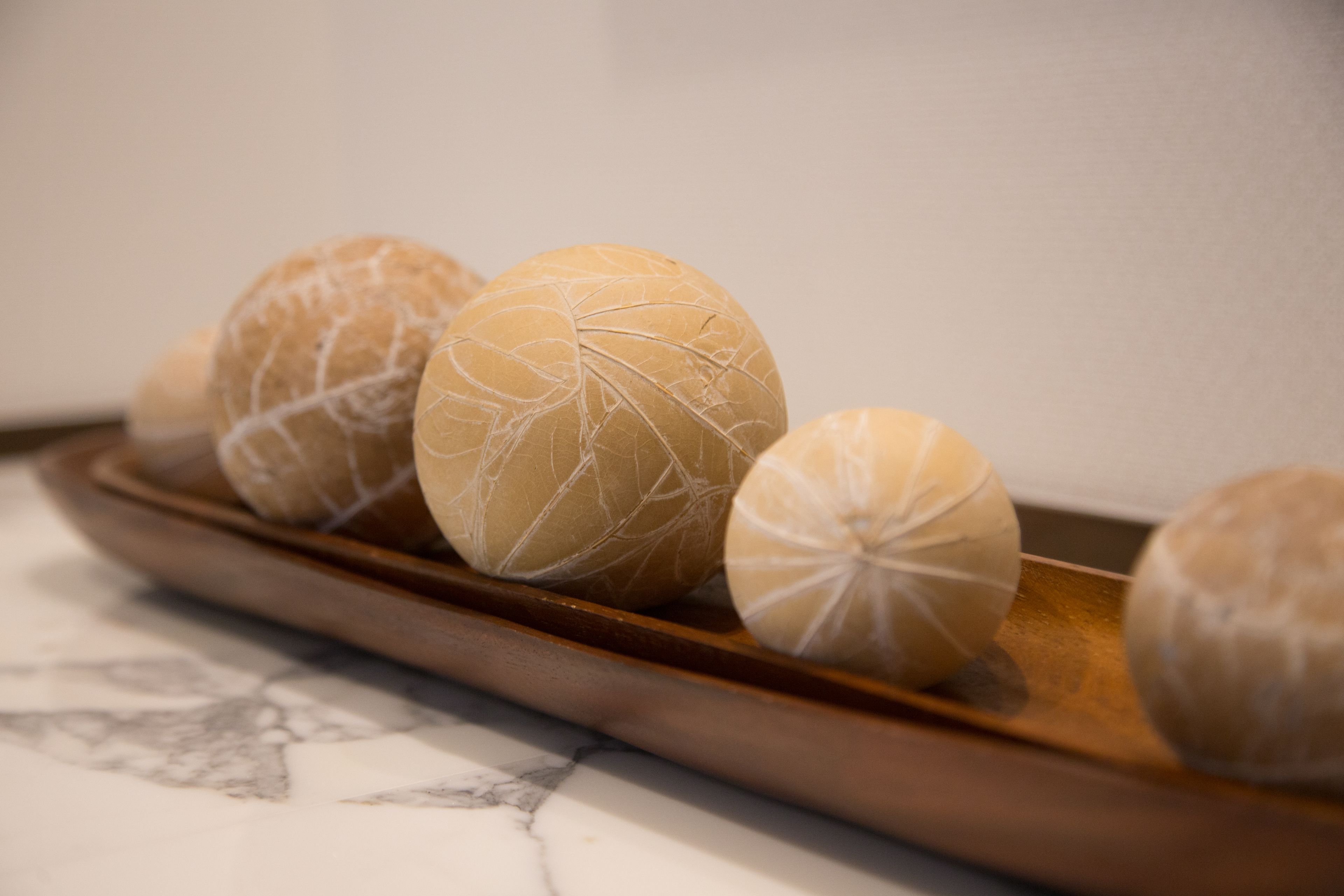 A wooden tray with several spherical objects.