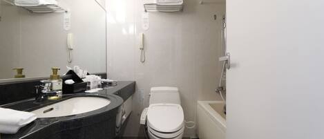 Un baño moderno con lavamanos, inodoro y bañera.